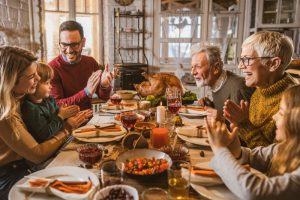 family-gathered-around-table-at-thanksgiving